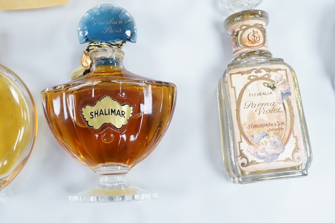 A Baccarat Guerlain perfume bottle in original box and a collection of other empty perfume bottles